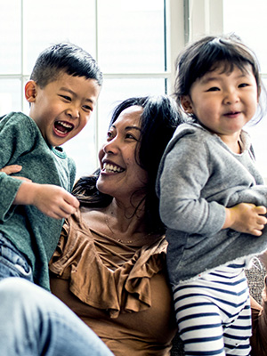 mom and two children laughing together