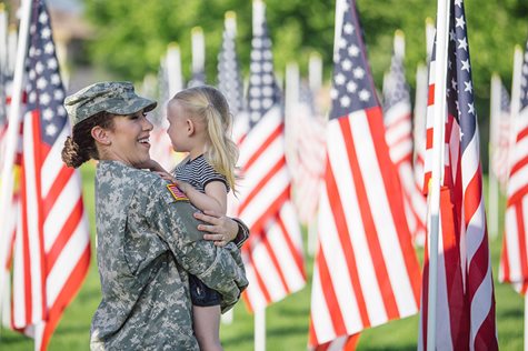 veteran mom and daughter near american flags