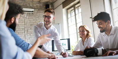 Staff members smiling at a work meeting