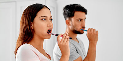 Couple brushing their teeth